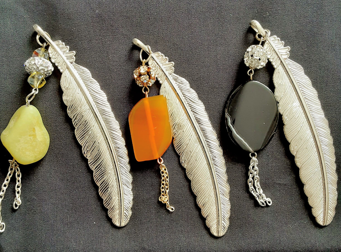Elegant feather bookmarks adorned with natural stones and subtle sparkle.
