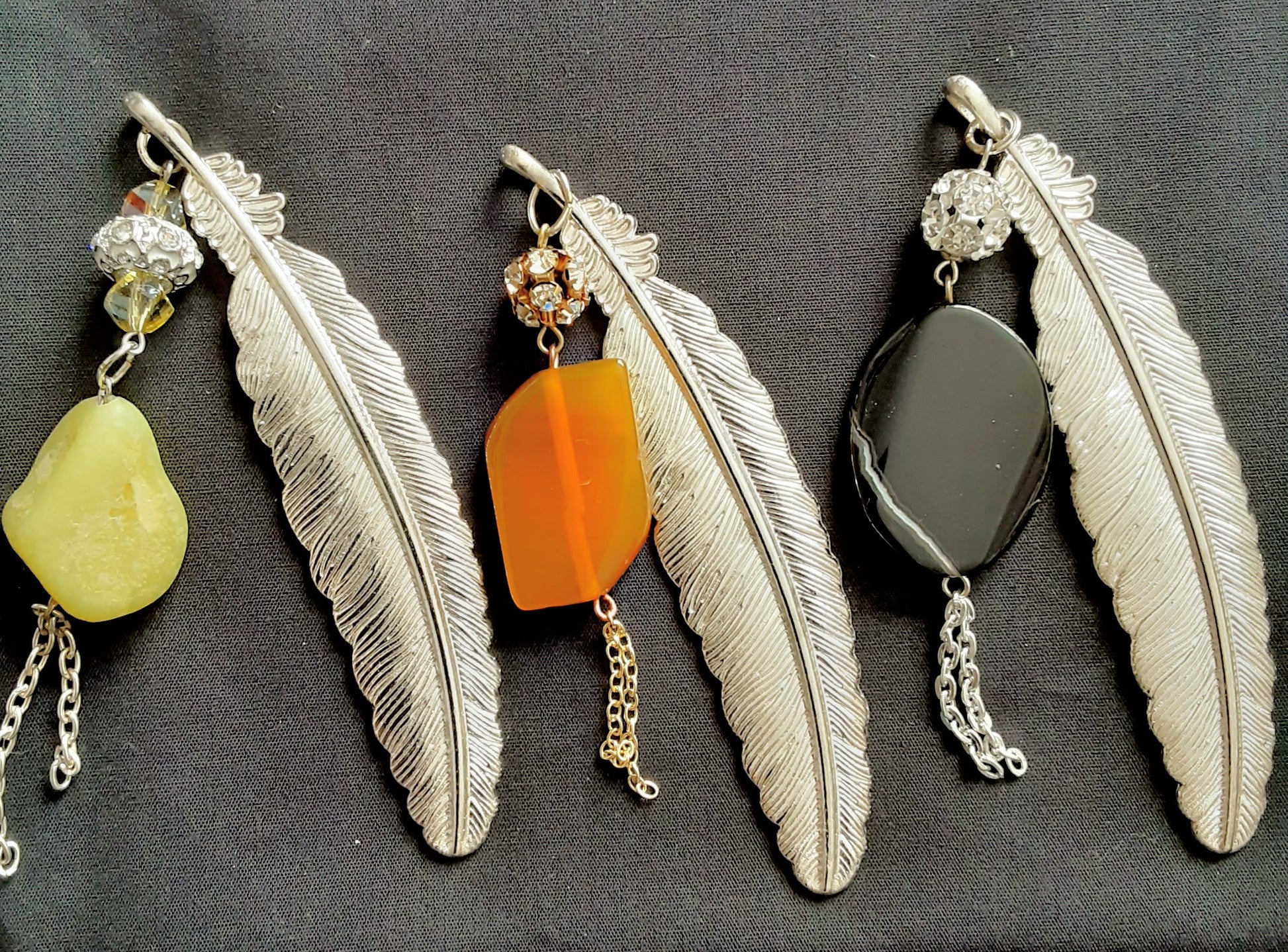 Elegant feather bookmarks adorned with natural stones and subtle sparkle.
